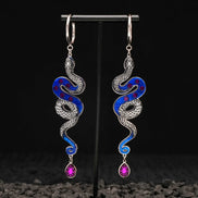 silver snake hoop earrings with purple gemstones and blue marble handmade on black background