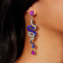 Load image into Gallery viewer, Snake-shaped earring with purple gemstones worn by a person