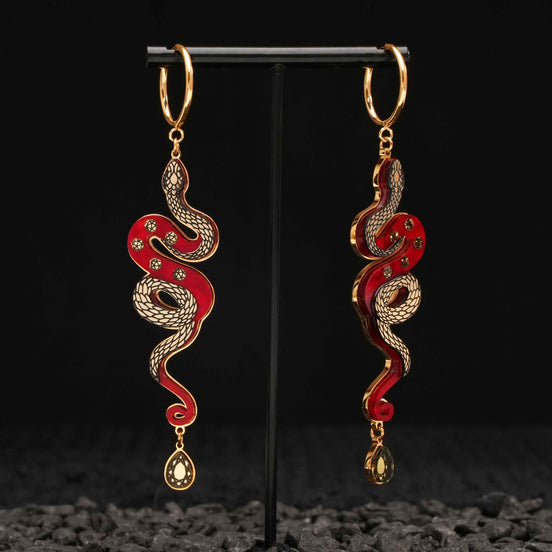 red and gold year of the snake gold hoop earrings on black background 