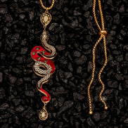 Snake-shaped pendant necklace on a dark textured background