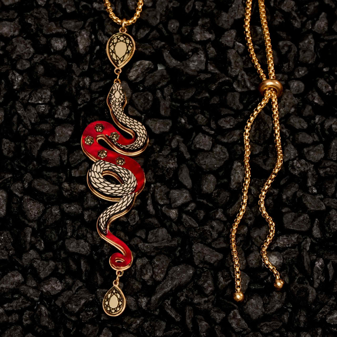 Snake-shaped pendant necklace on a dark textured background