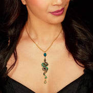 Woman wearing a gold necklace with a snake-shaped pendant