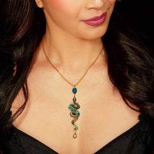 Load image into Gallery viewer, Woman wearing a gold necklace with a snake-shaped pendant