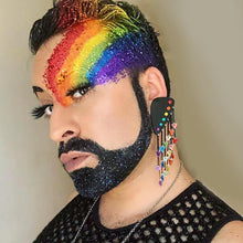 Load image into Gallery viewer, Maine And Mara Glittery KING STYLE Rainbow Warrior Pride Dangles Worn By Person With Bold Rainbow Makeup