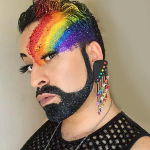 Maine And Mara Glittery KING STYLE Rainbow Warrior Pride Dangles Worn By Person With Bold Rainbow Makeup