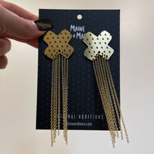 Load image into Gallery viewer, Pair Of Maine And Mara Unisex Gold Cross BISOUS KISSES + KINKS STUDS Statement Dangles With Long Gold Dangle Chains Shown With Packaging