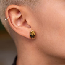 Load image into Gallery viewer, Closeup of person wearing handmade mini Gold Crown Jacket Glittery Studs by Maine and Mara