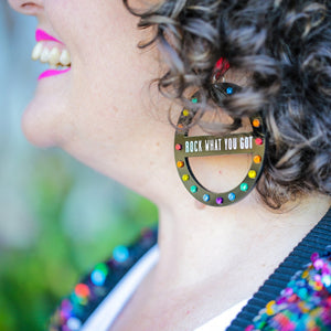 Person Wearing Maine And Mara Handmade Meaningful ROCK WHAT YOU GOT Rainbow Black Pride Hoop Earrings