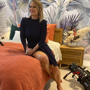 Shaynna Blaze Sitting On Bed Wearing Maine And Mara SHAYNNA Rainbow Triangle Pride Dangles
