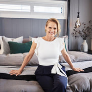 Smiling Shaynna Blaze Wearing Brushed Gold Wings Statement Earrings, Handmade In Australia