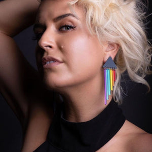 Person wearing Australian Handmade Maine and Mara Cheeky Chimes Earrings with RAINBOW Pride Dangles