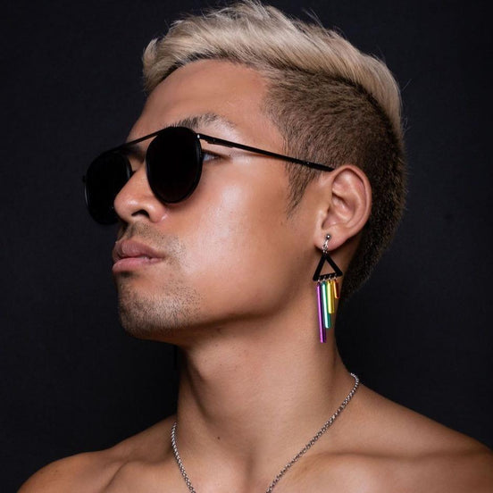 Person wearing Maine and Mara Clip-on Earrings with black triangle and RAINBOW Pride CHIMETTE Short Dangles