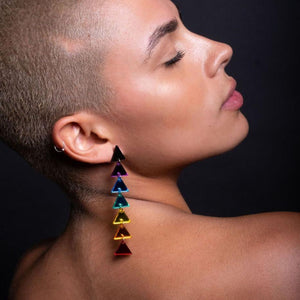 Person wearing Clip on GET DOWN Pride Rainbow Triangle Dangle Statement Earrings by Maine and Mara