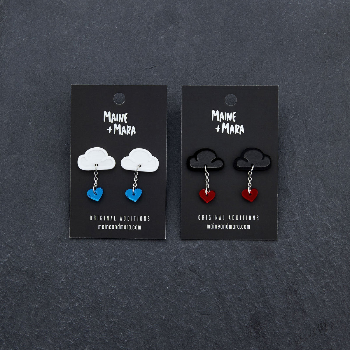Various Colours Of The LOVE RAINDROPS Cloud and Heart Earrings by Maine and Mara shown with packaging