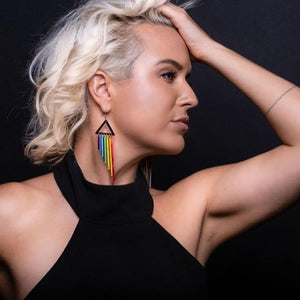 Person wearing Pride RAINBOW CHEEKY CHIMES Lightweight Statement Earrings handmade by Maine and Mara