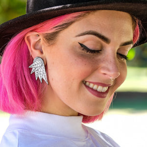Person wearing Handmade THE COCKIE COLLAB Wings Stud Earrings by Maine and Mara and Mulga the Artist