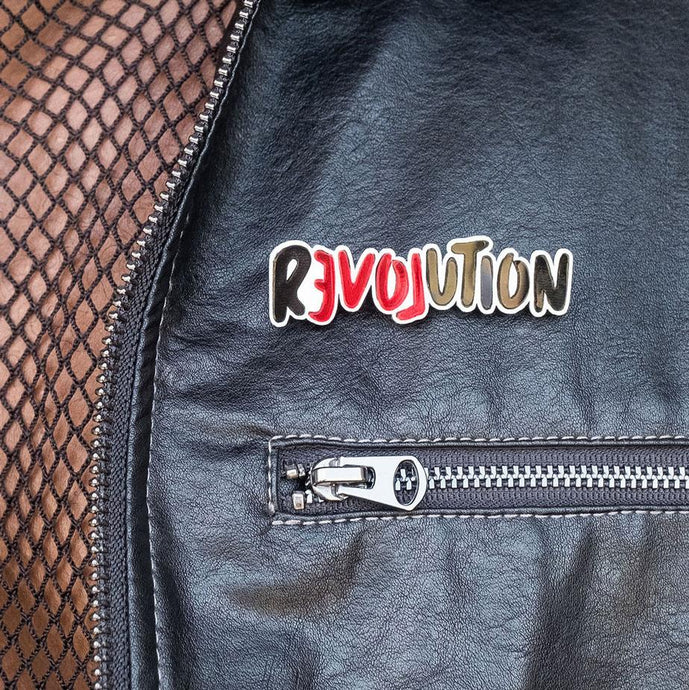 Meaningful LOVE REVOLUTION Statement Brooch worn on leather jacket by Maine and Mara
