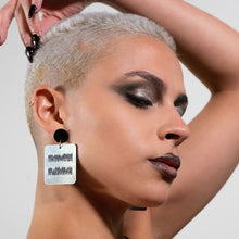 Load image into Gallery viewer, Person wearing Maine and Mara EQUALITY DANGLES Statement Earrings in Silver