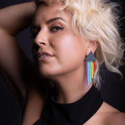 Person wearing pride RAINBOW CHEEKY CHIMES Lightweight Statement Studs handmade by Maine and Mara