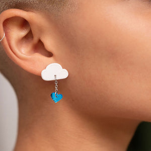 Closeup of Person wearing White and blue LOVE RAINDROPS Cloud and Heart Earrings by Maine and Mara
